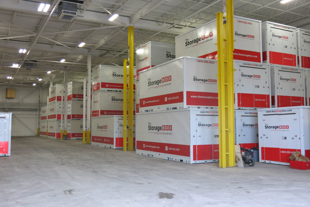Indoor storage units stacked in warehouse space.