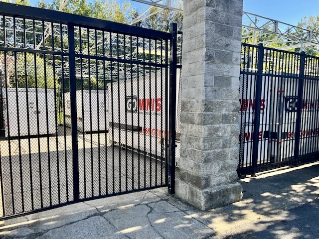 Stellar Container Rentals portable storage containers lined up on commercial site with white exterior and red doors