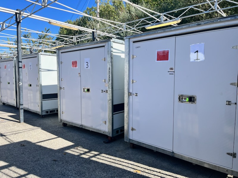 Stellar Container Rentals storage container deployed next to commercial trucks showing industrial applications
